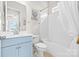 Bright bathroom featuring a blue vanity, white fixtures, and a shower-tub combination at 9319 Highclere Ct, Matthews, NC 28105