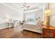 Bright bedroom features hardwood floors, tray ceilings, and multiple windows for natural lighting at 9319 Highclere Ct, Matthews, NC 28105