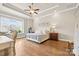 Calming bedroom with tray ceilings, hardwood floors, and large windows offer a serene retreat at 9319 Highclere Ct, Matthews, NC 28105