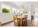 Bright dining room boasts beautiful hardwood floors, elegant lighting, and large windows for natural light at 9319 Highclere Ct, Matthews, NC 28105