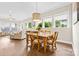 Dining area adjacent to the living room features a large window and hardwood floors at 9319 Highclere Ct, Matthews, NC 28105
