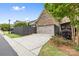 Garage and driveway of home, featuring brick accents and landscaping at 9319 Highclere Ct, Matthews, NC 28105