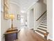 Welcoming foyer with hardwood floors and staircase is brightly lit with recessed lighting at 9319 Highclere Ct, Matthews, NC 28105