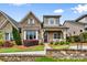 Charming brick home featuring a cozy front porch and professionally landscaped front yard at 9319 Highclere Ct, Matthews, NC 28105