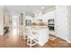 Open kitchen with island features white cabinets, granite countertops and stainless appliances at 9319 Highclere Ct, Matthews, NC 28105