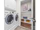 Convenient laundry room with modern washer and dryer, plus storage and seating area at 9319 Highclere Ct, Matthews, NC 28105