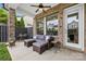 Covered patio with outdoor seating, ceiling fan, and brick columns at 9319 Highclere Ct, Matthews, NC 28105
