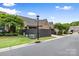 Street view of home showing brick exterior, landscaping, and lawn at 9319 Highclere Ct, Matthews, NC 28105