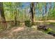 Wooden deck in backyard overlooking a wooded area with a rustic fire pit, blending nature with comfort at 118 Taylor Ct # 16, Mooresville, NC 28117