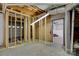 Unfinished basement area with exposed ceiling, framed walls, and a view of a garage door at 118 Taylor Ct # 16, Mooresville, NC 28117