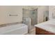 This bathroom features a shower with glass doors, a bathtub, and a white vanity with plenty of space at 118 Taylor Ct # 16, Mooresville, NC 28117