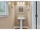 Classic bathroom features a pedestal sink, window, and beach-themed decorations at 118 Taylor Ct # 16, Mooresville, NC 28117