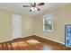 Bright bedroom with wood floors, a ceiling fan, and a sunny window at 118 Taylor Ct # 16, Mooresville, NC 28117