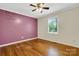 Comfortable bedroom with wood floors, a ceiling fan, and a painted accent wall at 118 Taylor Ct # 16, Mooresville, NC 28117