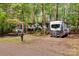 Front exterior view of a home and camper nestled among the trees, showcasing the serene property at 118 Taylor Ct # 16, Mooresville, NC 28117