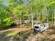 Home nestled in a wooded lot with RV parked in the driveway at 118 Taylor Ct # 16, Mooresville, NC 28117