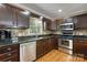 Well-equipped kitchen features stainless steel appliances, mosaic tile backsplash, and dark wood cabinetry at 118 Taylor Ct # 16, Mooresville, NC 28117