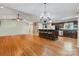 Open kitchen and dining area with a breakfast bar, stainless appliances, and hardwood floors at 118 Taylor Ct # 16, Mooresville, NC 28117