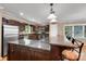 Open kitchen featuring a large breakfast bar with seating, stainless steel appliances, and tiled backsplash at 118 Taylor Ct # 16, Mooresville, NC 28117