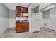 Basement kitchenette with dark cabinets, white refrigerator, microwave, and sink area at 118 Taylor Ct # 16, Mooresville, NC 28117