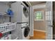 This laundry room features a washer and dryer, storage shelves, and a window for natural light at 118 Taylor Ct # 16, Mooresville, NC 28117