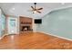 Inviting living room showcasing a brick fireplace, ceiling fan, and natural light at 118 Taylor Ct # 16, Mooresville, NC 28117