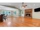Spacious living room boasting hardwood floors, a vaulted ceiling, and a cozy brick fireplace at 118 Taylor Ct # 16, Mooresville, NC 28117