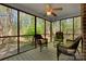 This screened porch features a wooded view, ceiling fan, and comfortable seating to enjoy the outdoors at 118 Taylor Ct # 16, Mooresville, NC 28117