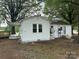 Rear view of a cozy white home showcasing its simple design and compact layout, ready for customization at 135 Hendren Ln, Hiddenite, NC 28636