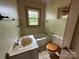 Bathroom with vintage fixtures, including a sink, toilet, and tub at 135 Hendren Ln, Hiddenite, NC 28636