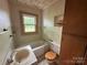 A cozy bathroom with a tub/shower combo, vanity, and classic fixtures, with natural light at 135 Hendren Ln, Hiddenite, NC 28636