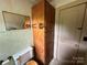 Modest bathroom featuring a vintage cabinet and neutral-toned fixtures at 135 Hendren Ln, Hiddenite, NC 28636