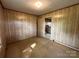 This cozy bedroom with wood paneling offers a relaxing space and easy access to the rest of the house at 135 Hendren Ln, Hiddenite, NC 28636
