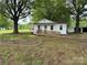 Quaint single-story home with front yard, front ramp, and lush greenery surrounding the property at 135 Hendren Ln, Hiddenite, NC 28636