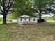 Quaint single-story home with a welcoming ramp, surrounded by mature trees at 135 Hendren Ln, Hiddenite, NC 28636