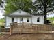 Charming single-story home with white siding, front ramp, and mature trees at 135 Hendren Ln, Hiddenite, NC 28636