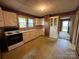 Functional kitchen featuring a range, sink and built-in cabinets and linoleum flooring at 135 Hendren Ln, Hiddenite, NC 28636