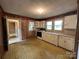Functional kitchen with white cabinets, matching appliances, and linoleum flooring at 135 Hendren Ln, Hiddenite, NC 28636