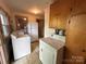 Spacious laundry area includes washer, dryer, and refrigerator, offering convenience and functionality at 135 Hendren Ln, Hiddenite, NC 28636