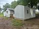 Exterior view of the storage outbuildings with corrugated steel siding at 135 Hendren Ln, Hiddenite, NC 28636