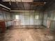 Interior view of shed featuring corrugated metal walls, a wooden floor, and ample space for storage or hobbies at 135 Hendren Ln, Hiddenite, NC 28636