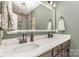 Elegant bathroom with double sinks, granite countertop, a large mirror, and modern fixtures at 135 Westerwood Dr, Rock Hill, SC 29732