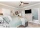 Cozy bedroom features neutral walls, a ceiling fan, and adjoining bathroom at 135 Westerwood Dr, Rock Hill, SC 29732