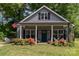 Charming home featuring a welcoming porch, neat landscaping, and an American flag at 135 Westerwood Dr, Rock Hill, SC 29732