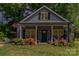 Charming home with a landscaped front yard, welcoming porch, and American flag, exuding curb appeal at 135 Westerwood Dr, Rock Hill, SC 29732