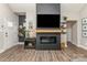 Cozy living room featuring hardwood floors, a modern fireplace, and a large mounted television at 135 Westerwood Dr, Rock Hill, SC 29732