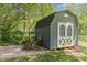 Storage shed in backyard with double doors, providing convenient outdoor storage space at 135 Westerwood Dr, Rock Hill, SC 29732