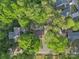 An aerial view shows the home nestled among mature trees in a neighborhood setting at 1420 Columbus St, Albemarle, NC 28001