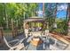 Backyard features a pergola seating area and stone fire pit perfect for outdoor gatherings at 1420 Columbus St, Albemarle, NC 28001