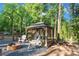 Backyard features a pergola seating area and stone fire pit perfect for outdoor gatherings at 1420 Columbus St, Albemarle, NC 28001